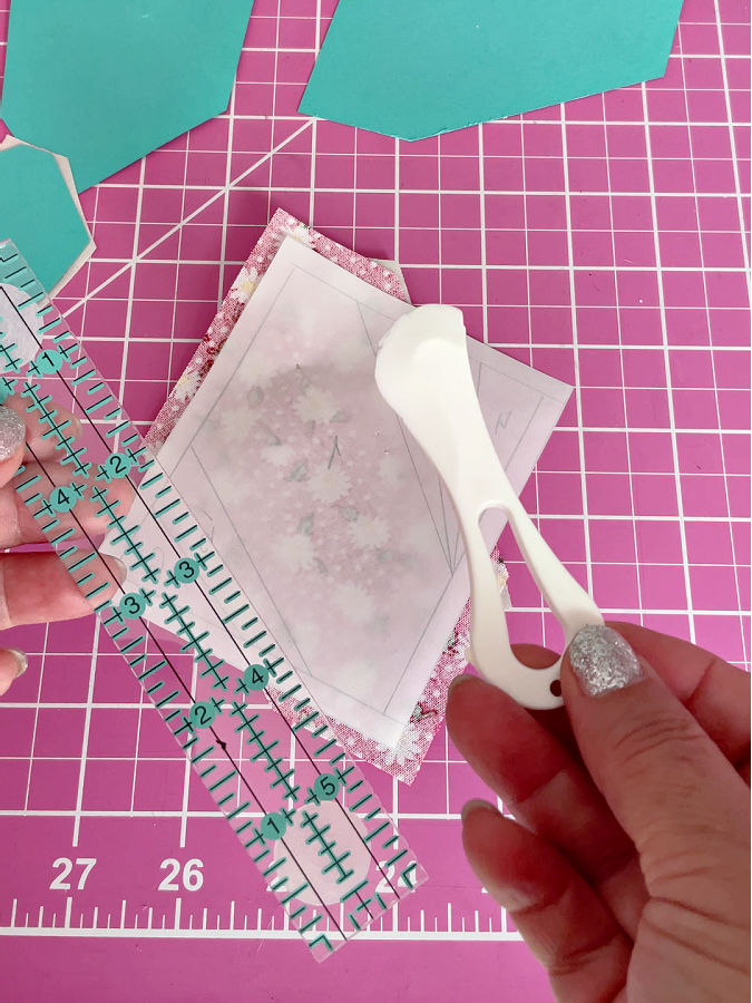 using a hera marker to crease the paper on the line of the future folding to make the operation easier