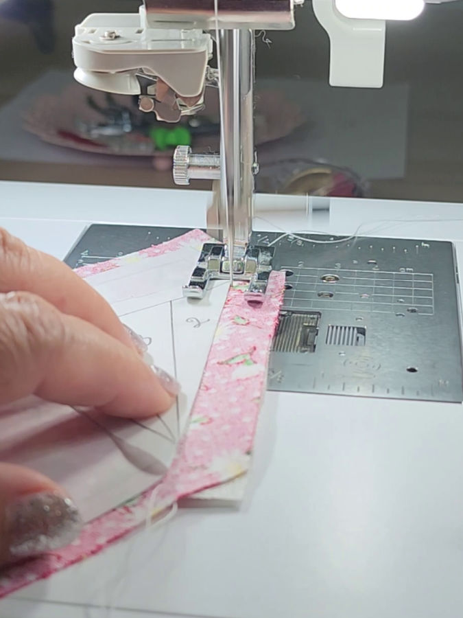 stitching the pieces 1 and 2 close to the paper edge