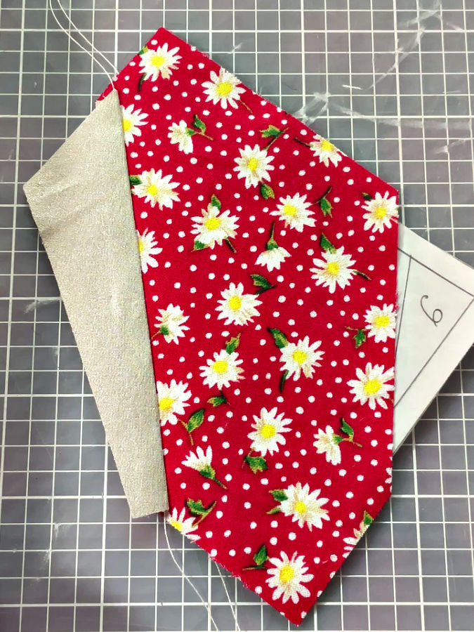 fabric piece opened after the seam is pressed using a finger presser