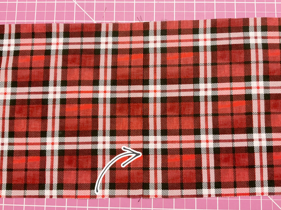 the pieces of material shown after sewing the match is perfect an arrow points to the matching line which is nearly invisible otherwise