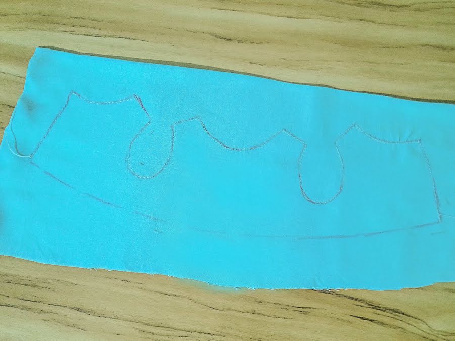 piece of fabric with a drawn pattern from a bunny doll dress without the seam allowance marked