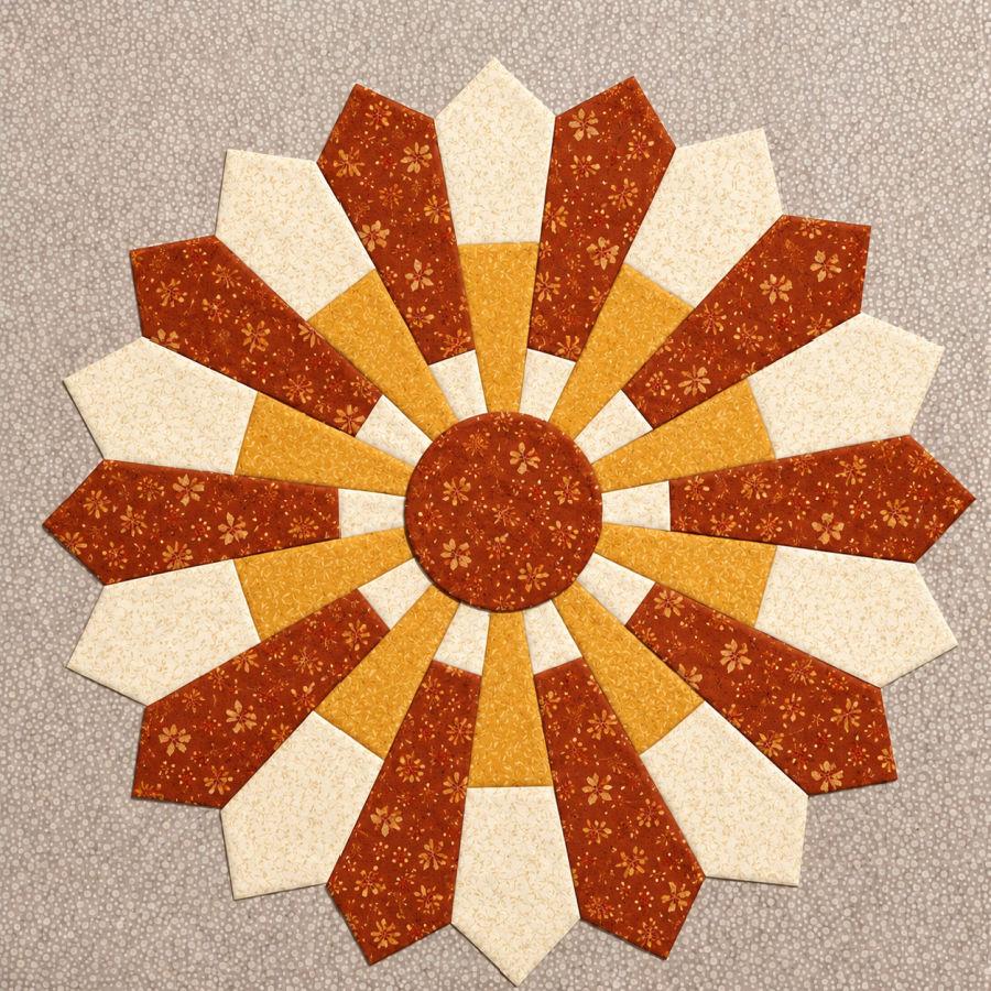 dresden plate quilt block in red orange and white colors with a floral motif