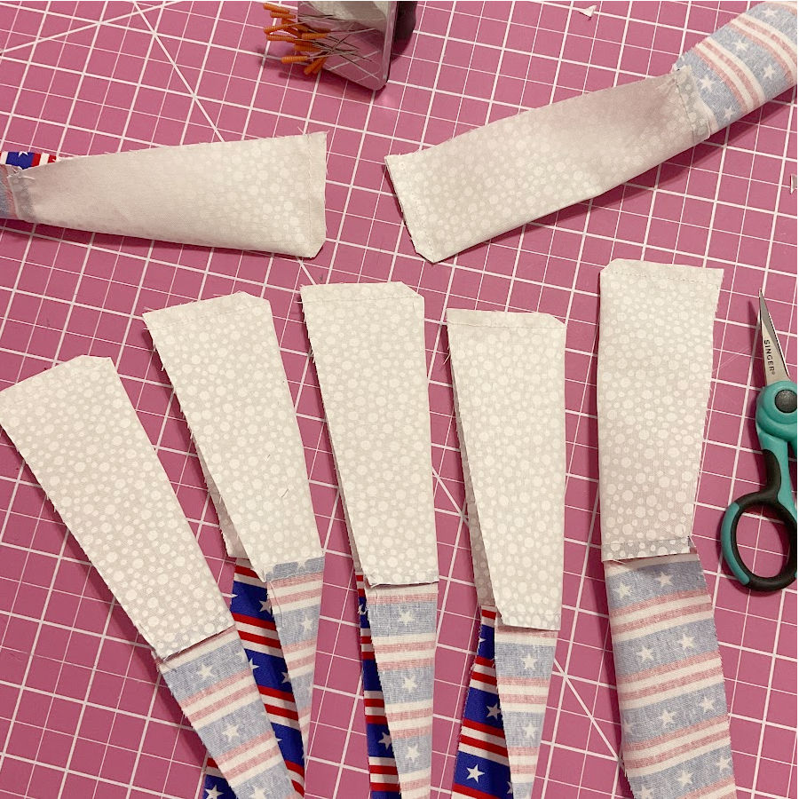 blue blades shown sewn at the wide edge but separated from each other and with the corner of the seam trimmed