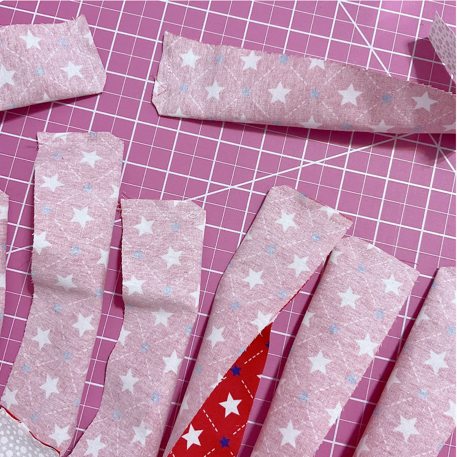 red blades shown sewn at the wide edge but separated from each other and with the corner of the seam trimmed