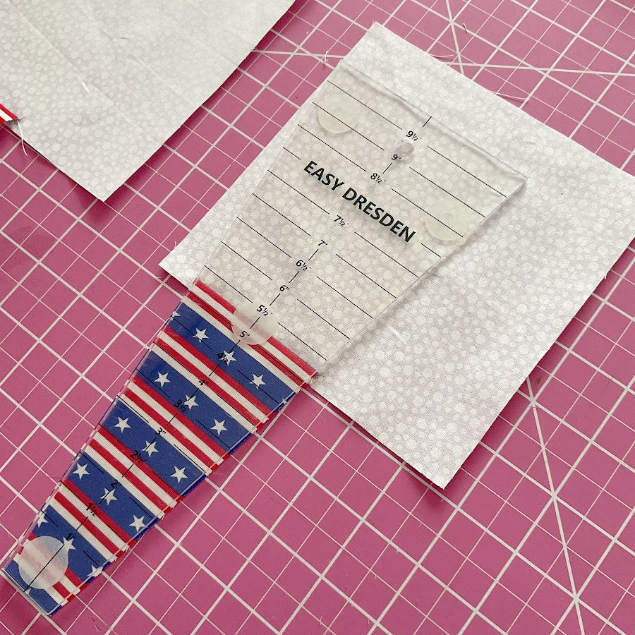 the dresden ruler aligned with the blue piece on the blue/white construction sewn previously