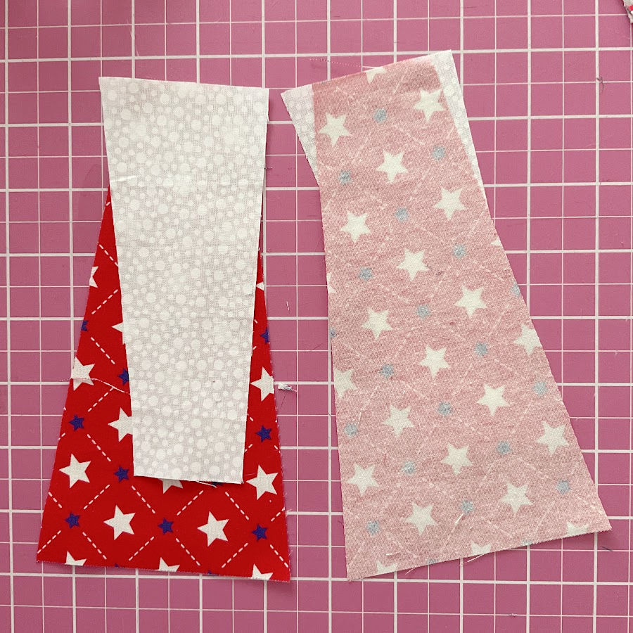 the white pieces saved after cutting arranged on the red pieces seen both from the right and wrong sides