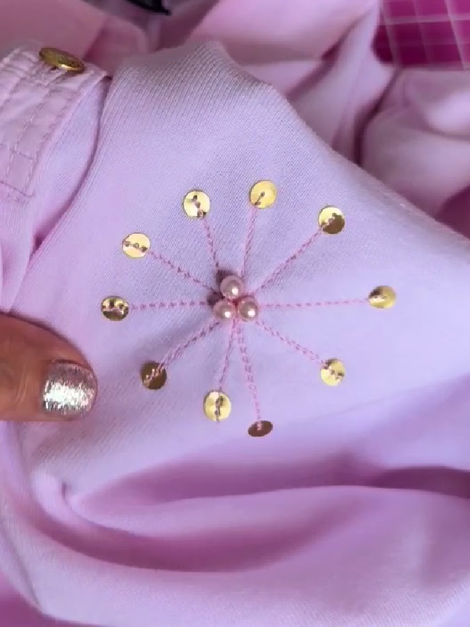 three beads sewn by hand in the center of the embellishment