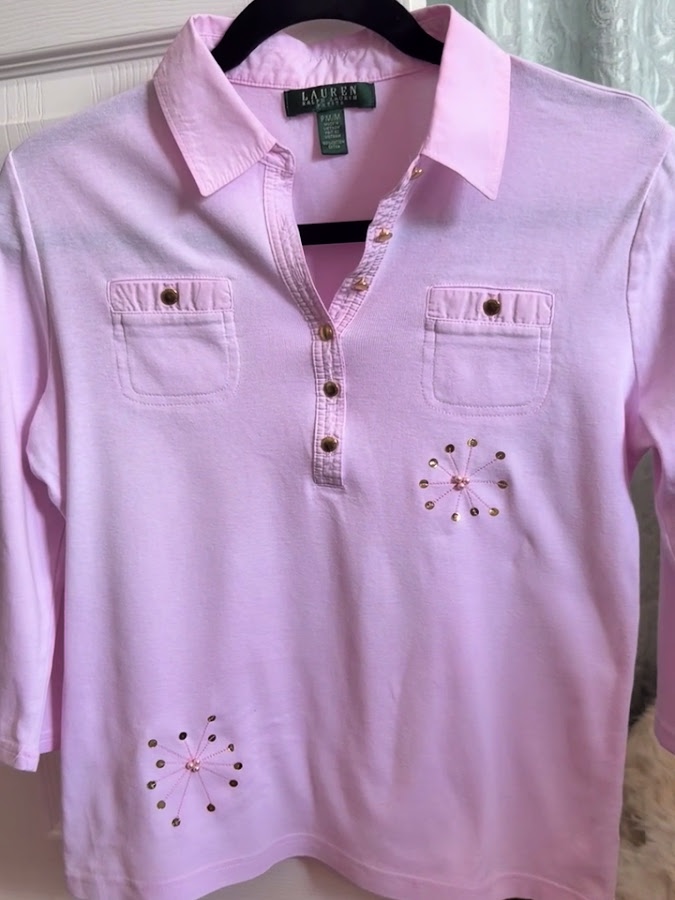 the shirt presented from the front with the two embellishments covering the stains