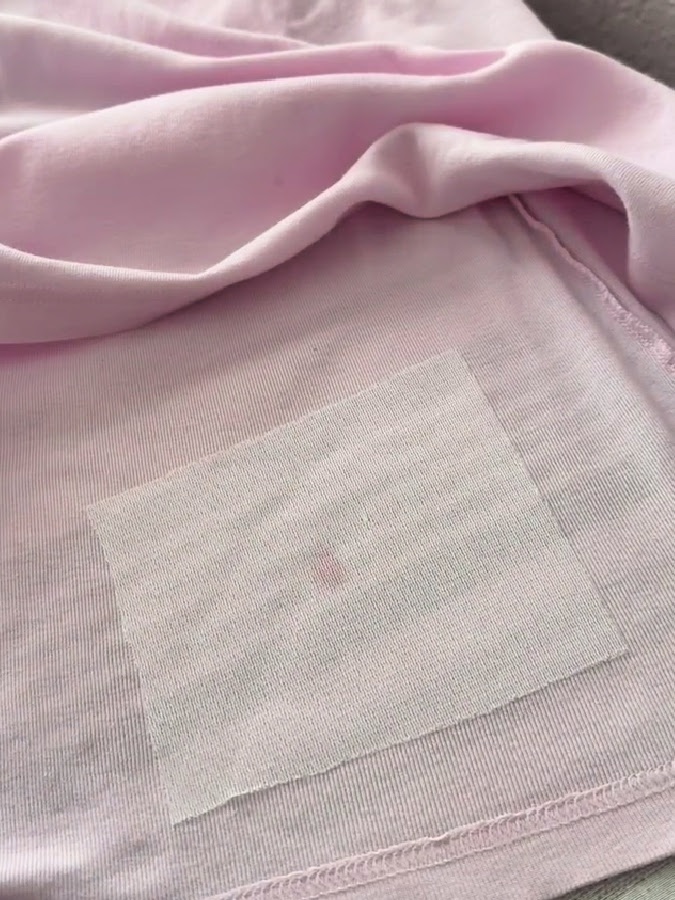 a piece of fusible interfacing lightly fused over the area with the stain