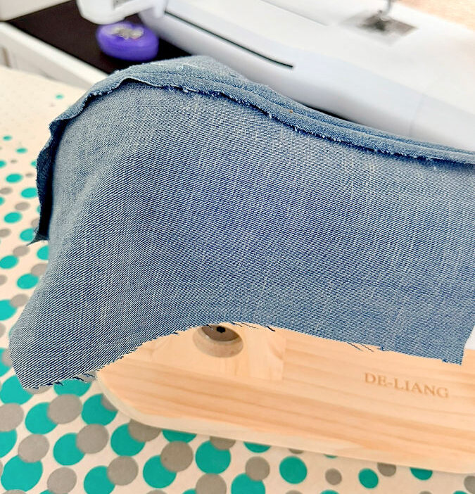 a piece of denim with a princess seam arranged over the corset ironing tool