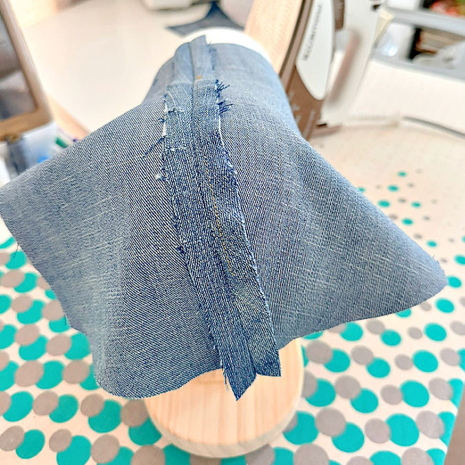 a piece of denim with a princess seam draped on the corset ironing board seen from the front