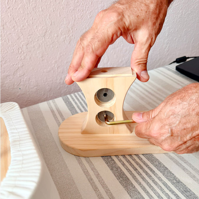 a man hands shown while assembling the corset ironing tool