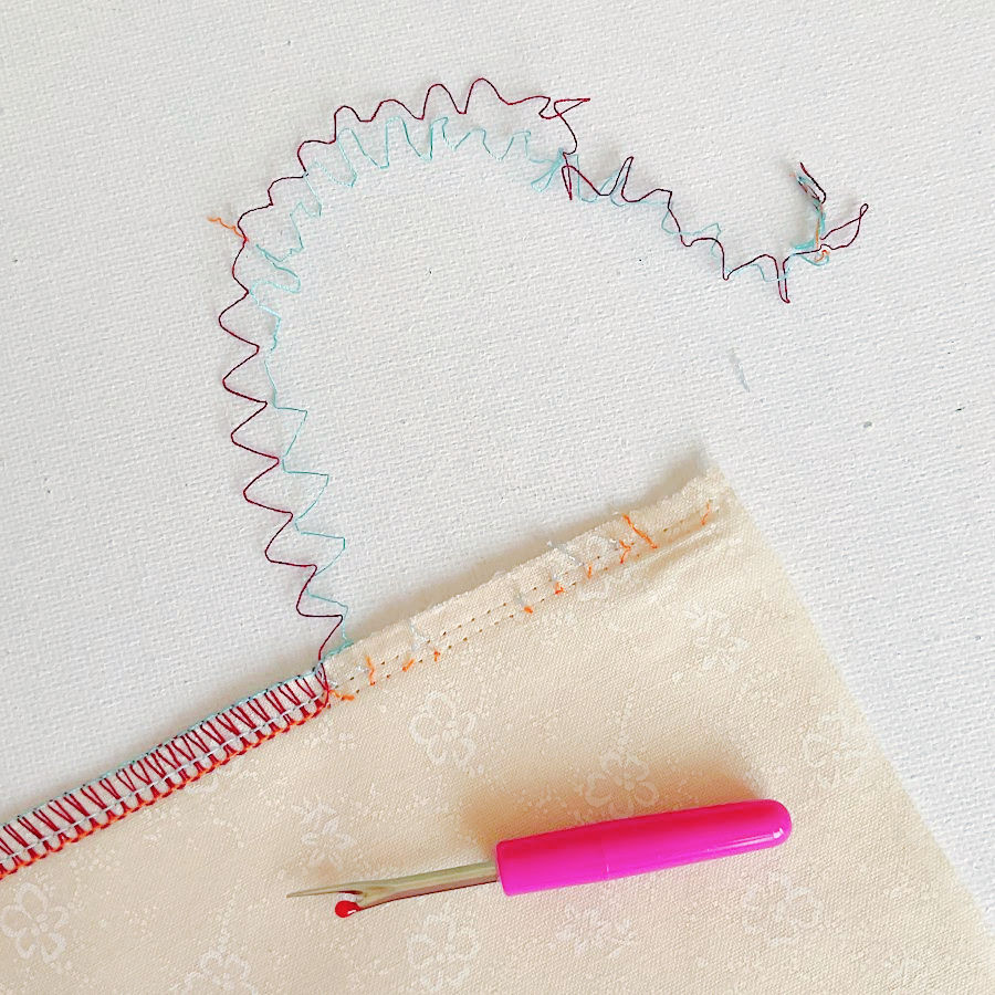 a seam made by serger shown coming apart easily after the needle thread was removed