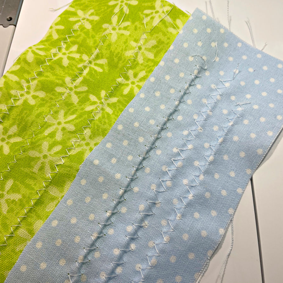 multiple rows of zigzag stitches on two pieces of material showing the tunneling problem