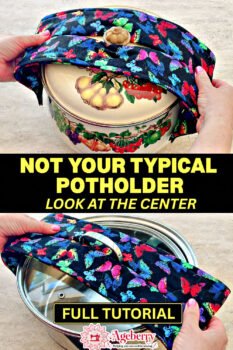 Close-up of a wrap-style quilted potholder placed over the handles of a ceramic pot lid and a glass lid. The butterfly-print fabric potholder has a center opening that fits around the handle while the padded ends protect both hands. An unusual DIY pot holder sewing pattern for lifting hot lids and cookware.