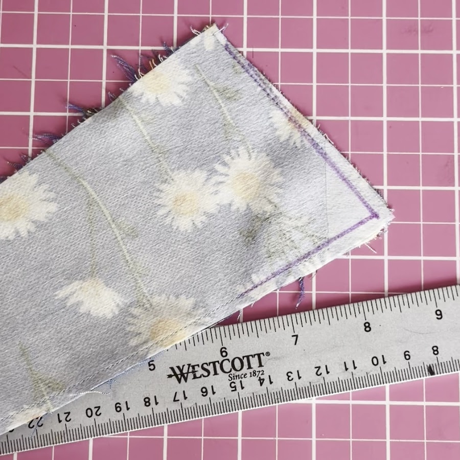 Using a removable fabric marker, draw a new stitching line approximately 1/8 inch inside the original seamline near the damaged corner