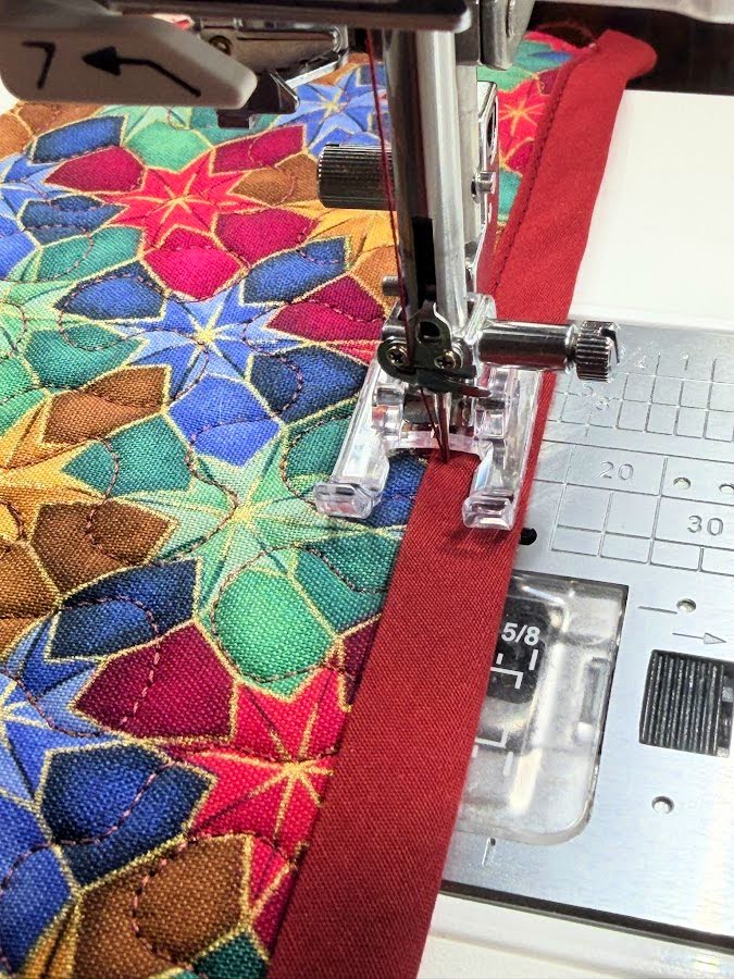 sewing the bjas strip to the fabric using the open toe machine foot