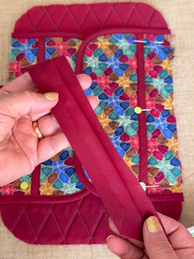 a womans hands holding the binding for the organizer to c=heck if there are any problems