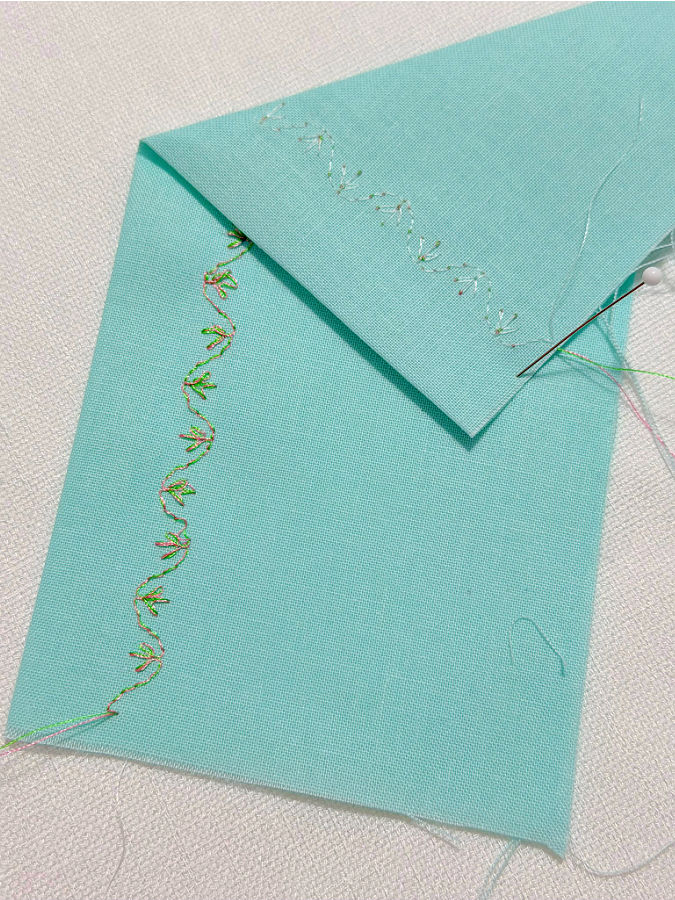 decorative stitch made with a double eye needle shown on both front and back sides the back side has threads of a different color close to the color of the material