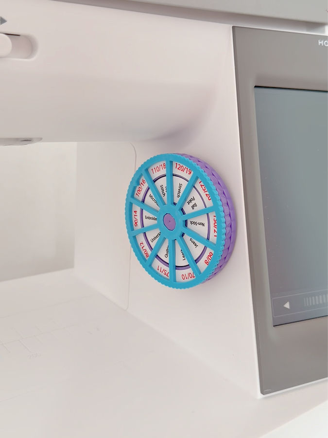 close up of the needle noter attached to a sewing machine