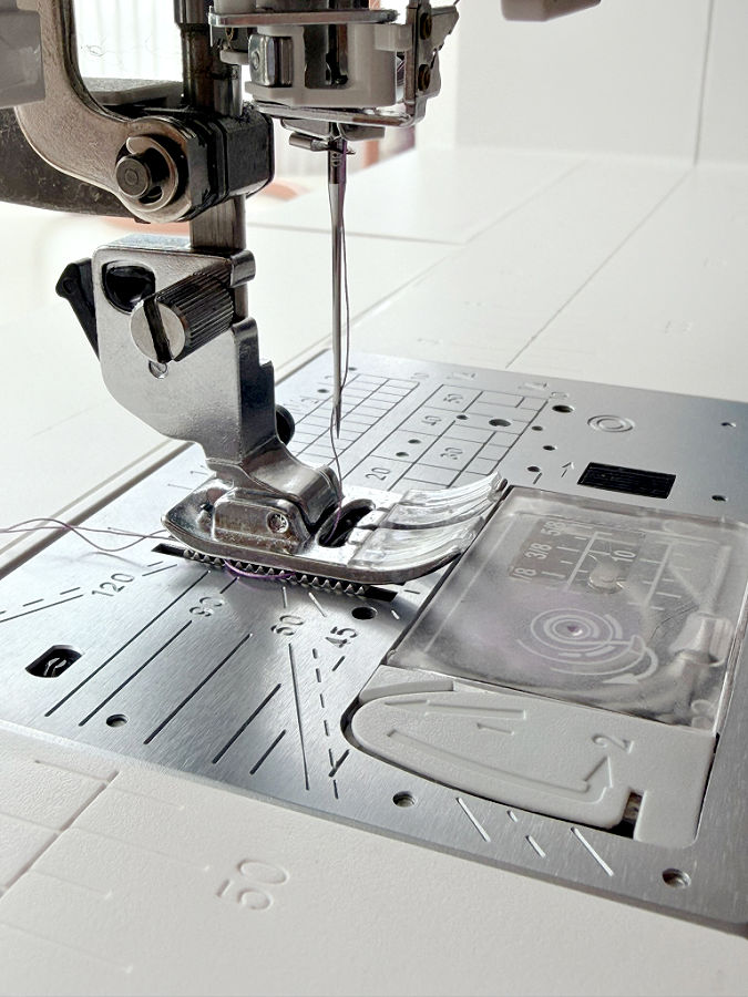 close-up of the needle assembly of a sewing machine the needle type and size are not easy to determine