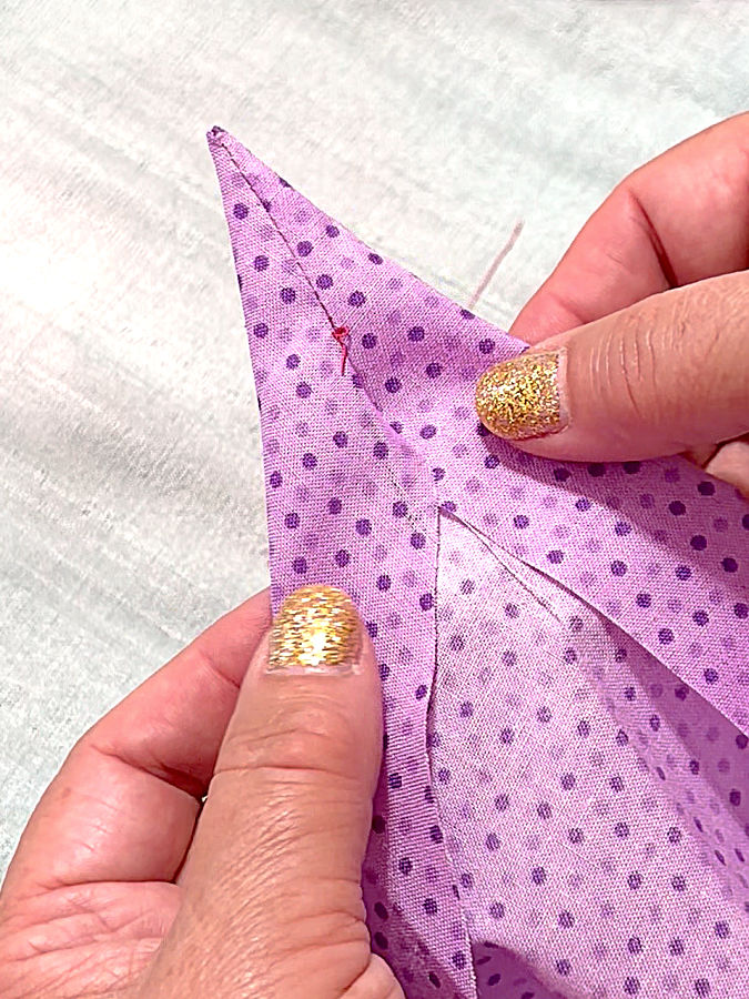 a woman holding the fabric after turning