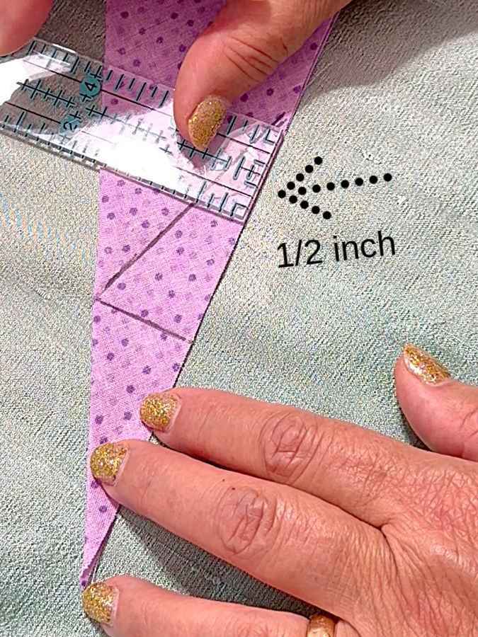 a womans hands holding a ruler while measuring a distance of 1/2 inches an arrow points to the ruler the words 1/2 inch on the image