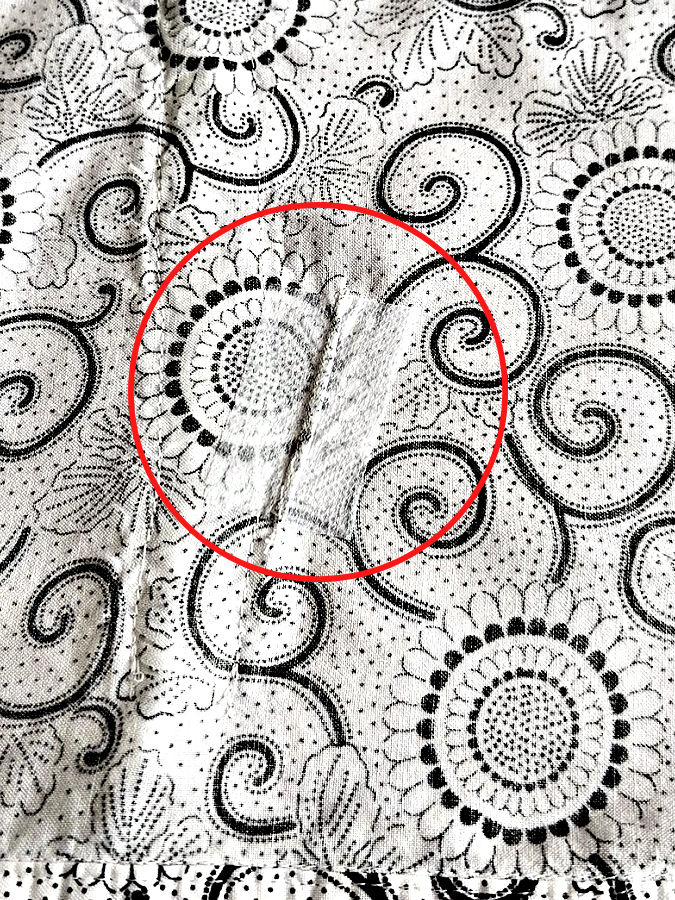 the repaired area seen from the wrong side a red circle highlights the area