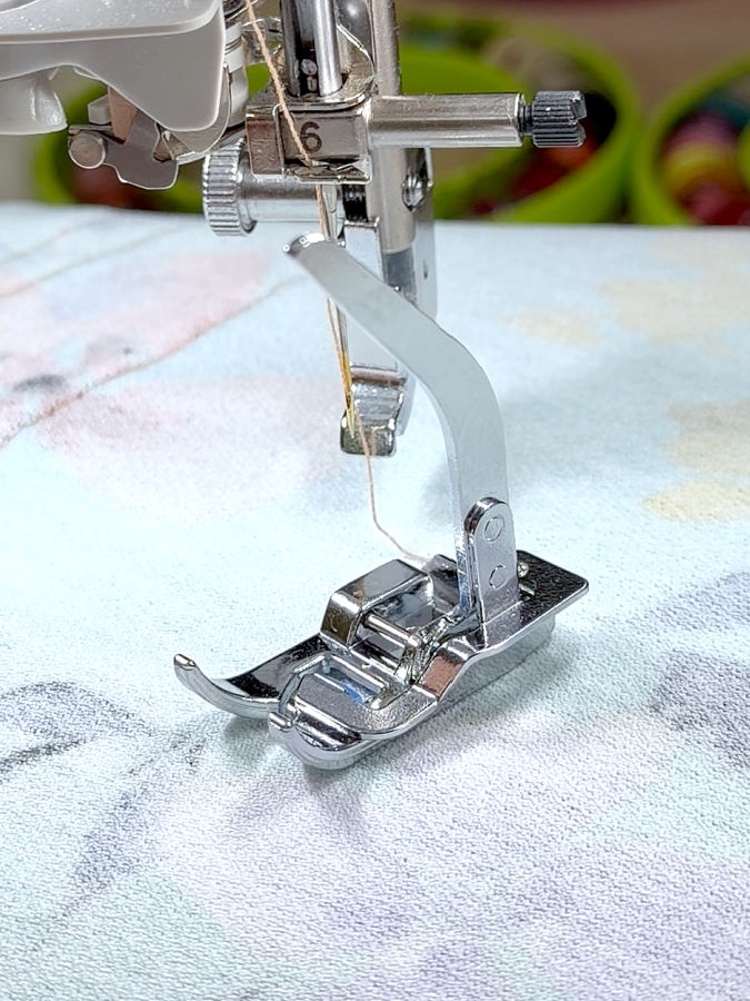 the foot support assembly of a sewing machine and the knit presser foot close to it but not mounted