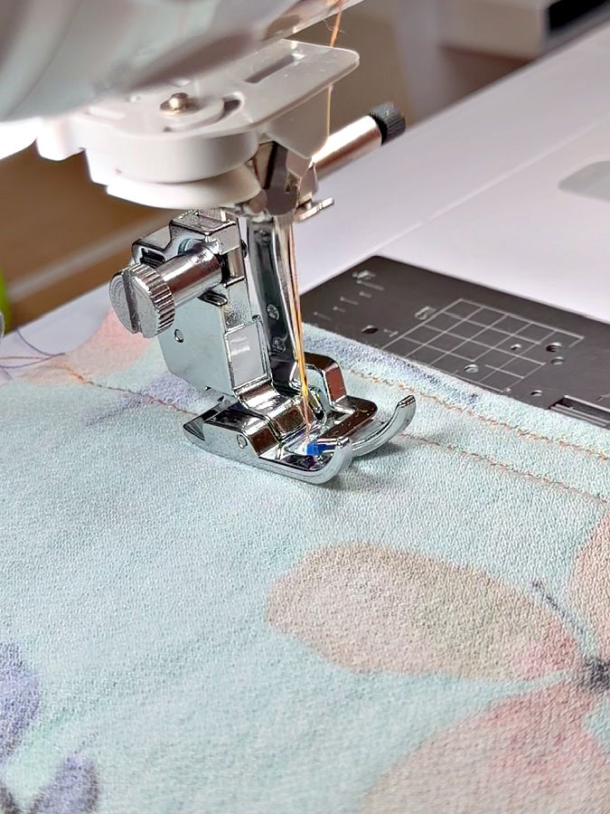 the knit presser foot installed in a sewing machine while the needle is down