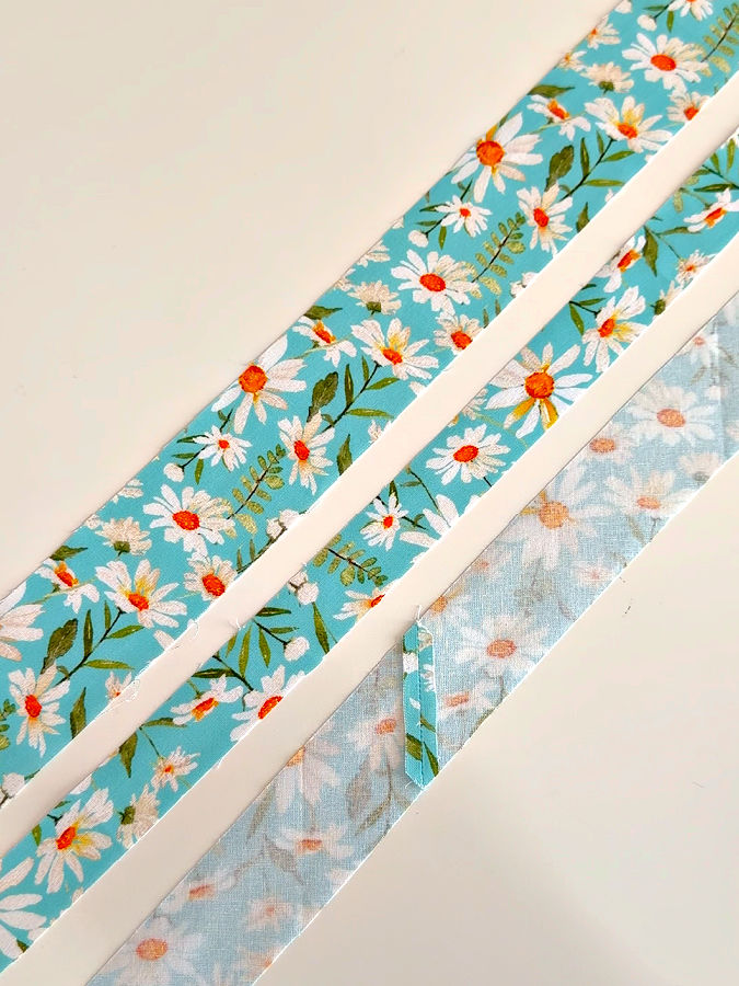 three strips of fabric of various widths