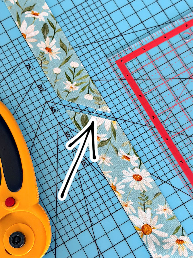 a strip of fabric cut at 45 degrees arranged for joining with another strip cut the same