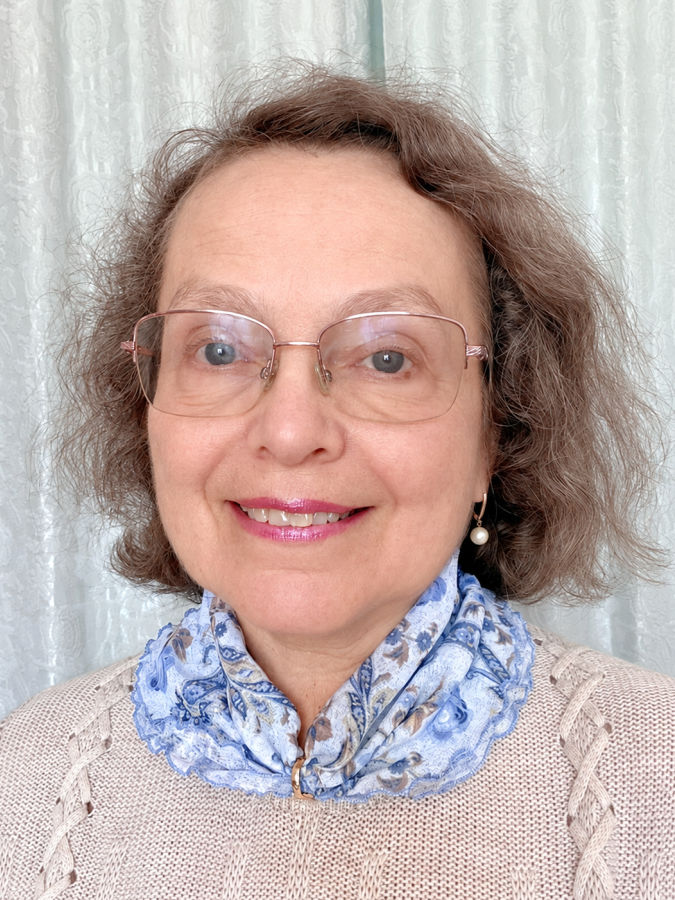 a woman wearing a lace blouse and a scarf