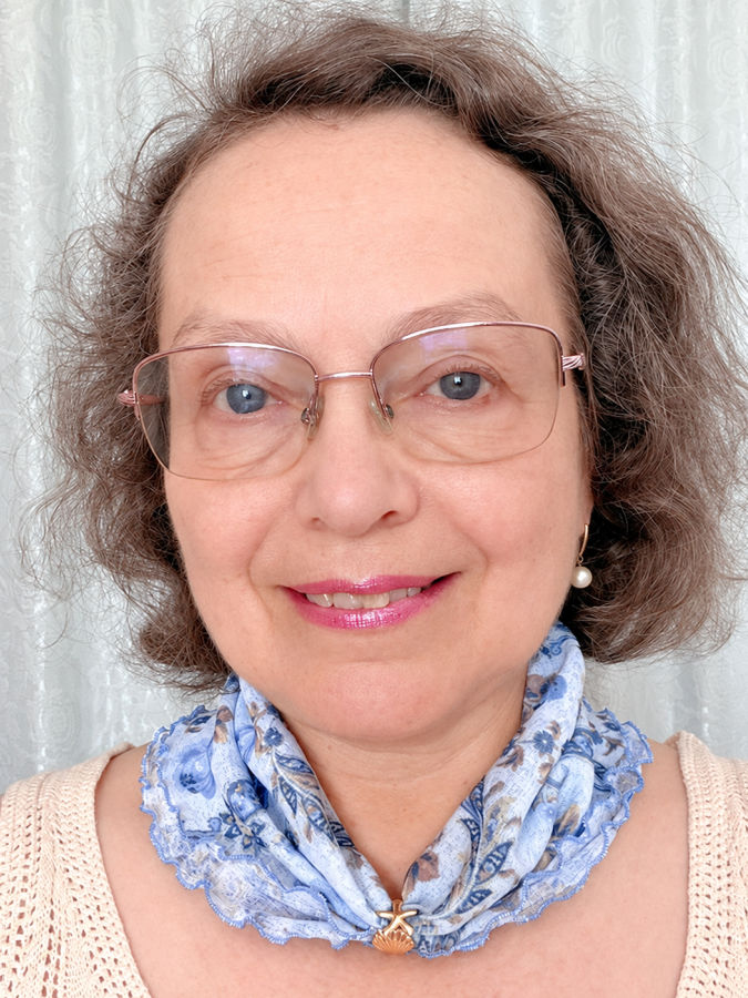 closeup of a woman wearing a lace blouse and a scarf