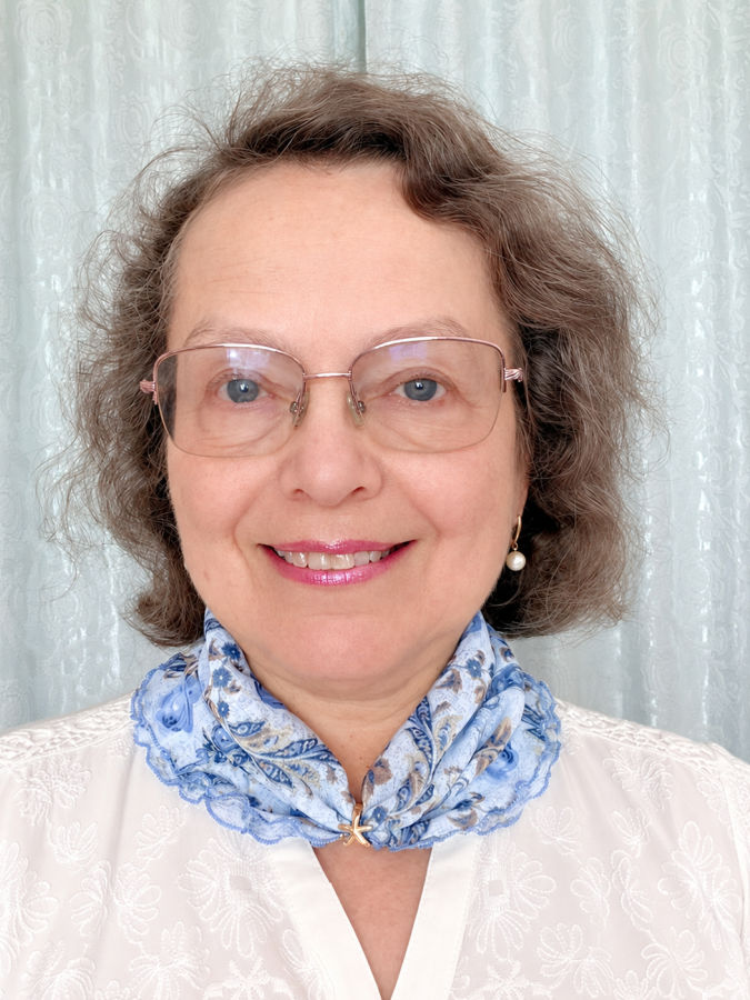 a woman wearing a white blouse and a scarf