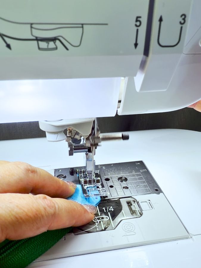 stitching the tab on the sewing machine