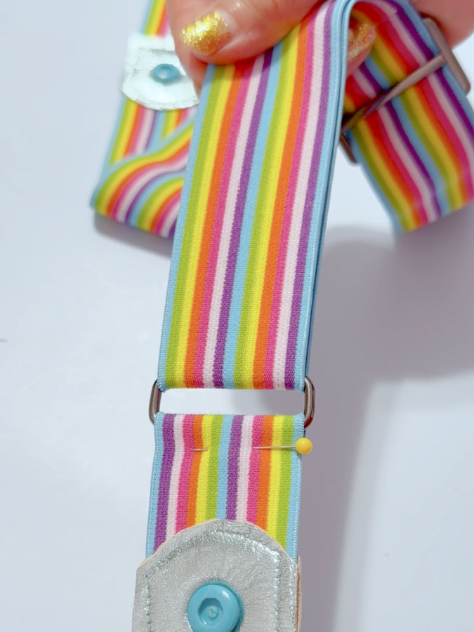 the longer piece of elastic is passed through the loop fastened to the short piece