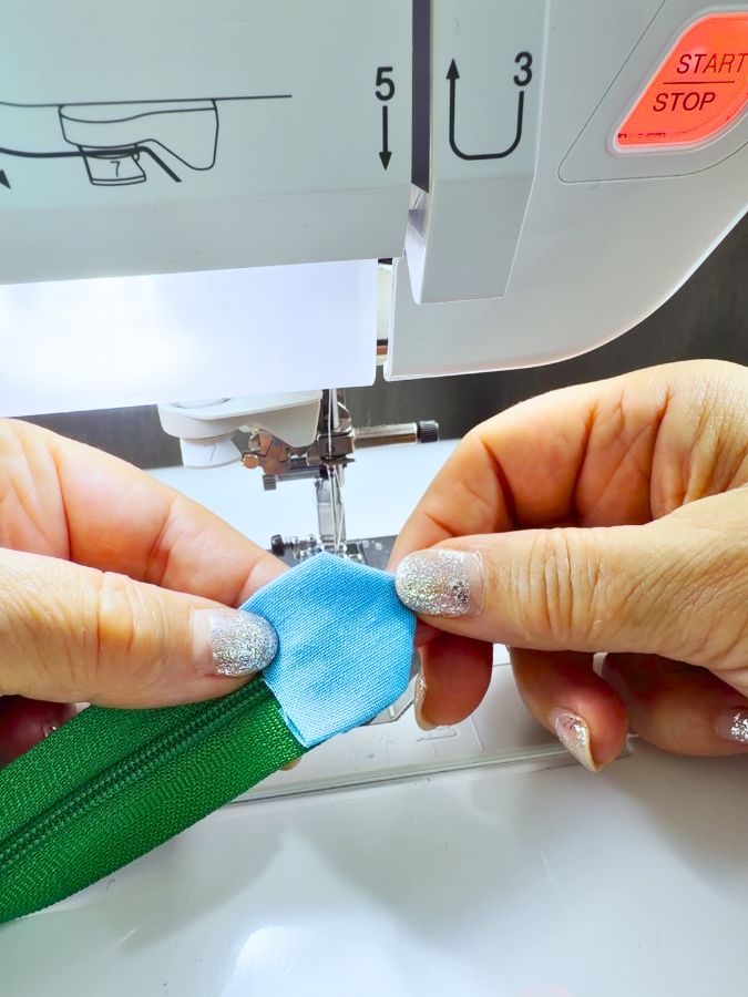 a woman holds the shaped fabric which already has the shape of the tab