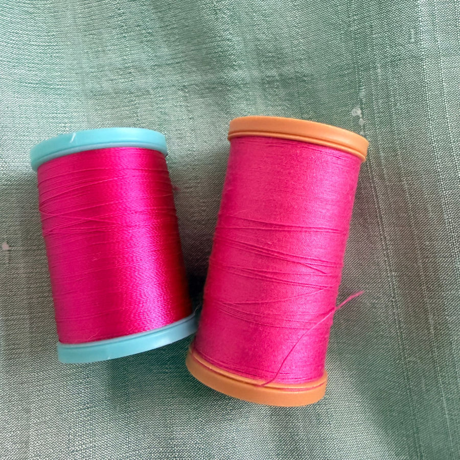 two coats and clark spools one eloflex on a light blue support the other cotton on light brown support
