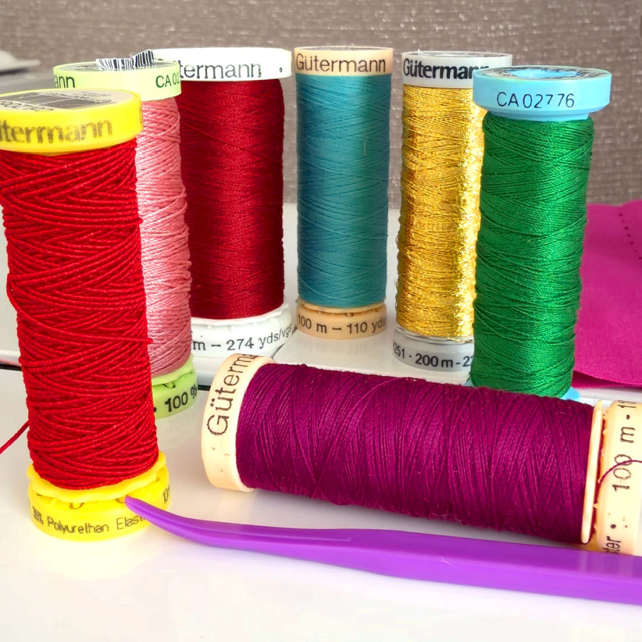 seven gutterman spools all with support of a different color