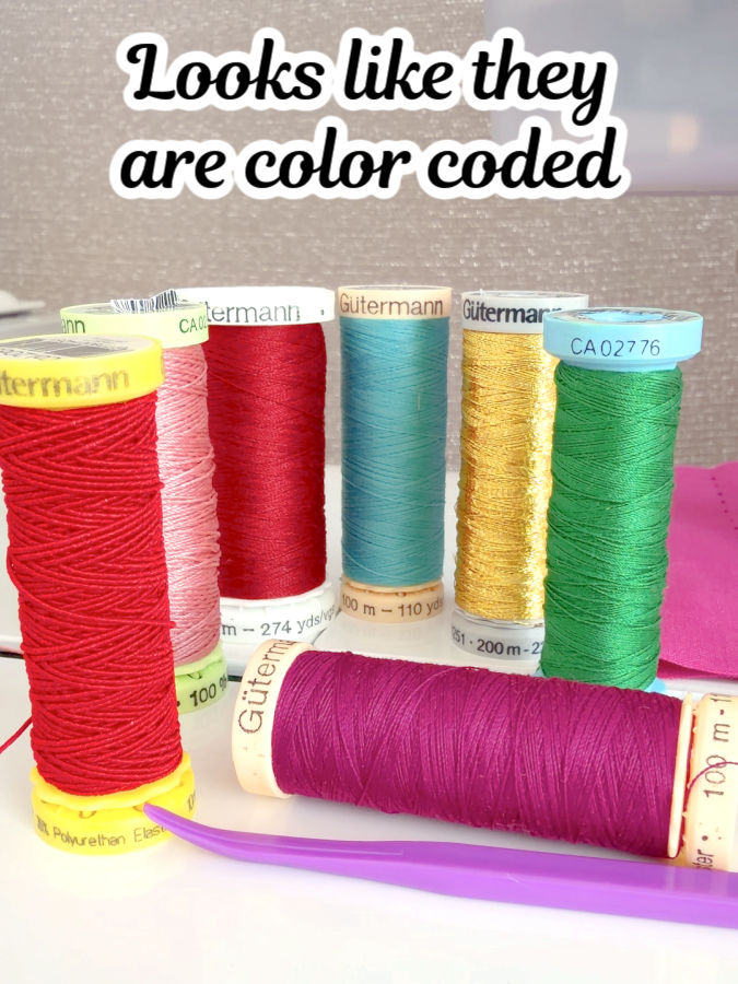 spools of thread with the support having various colors the text looks like they are color coded at the top