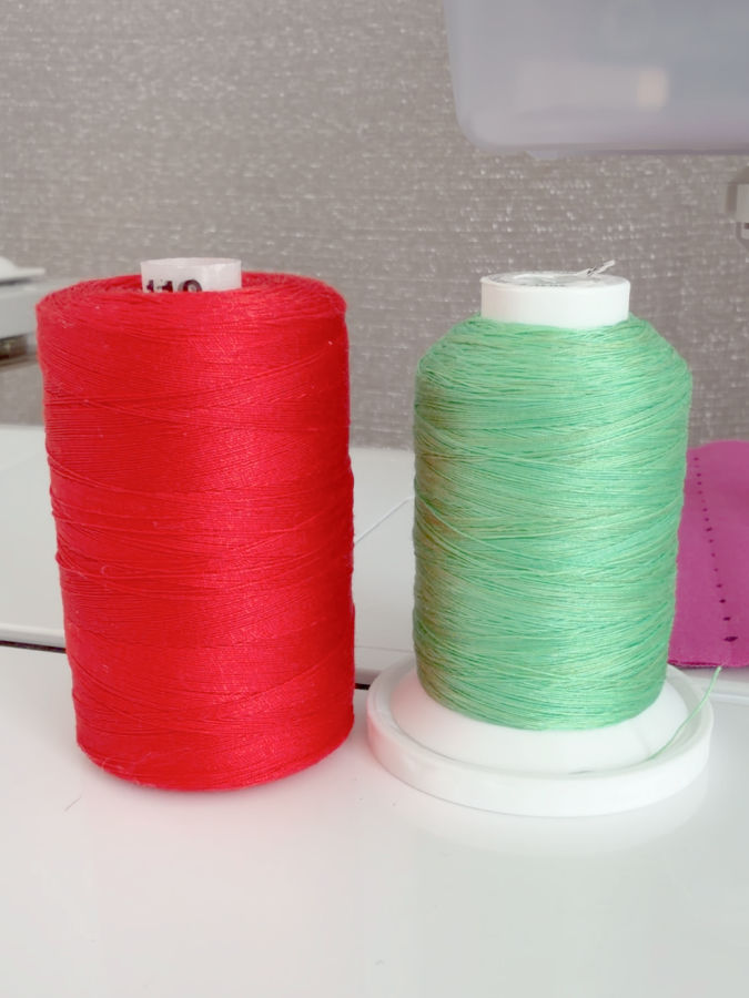 two spools of thread one with a large lower part the other without