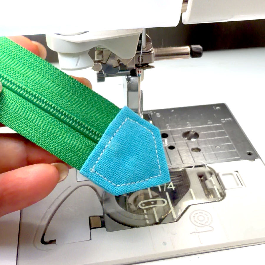 the zipper end tab finished a sewing machine in the background